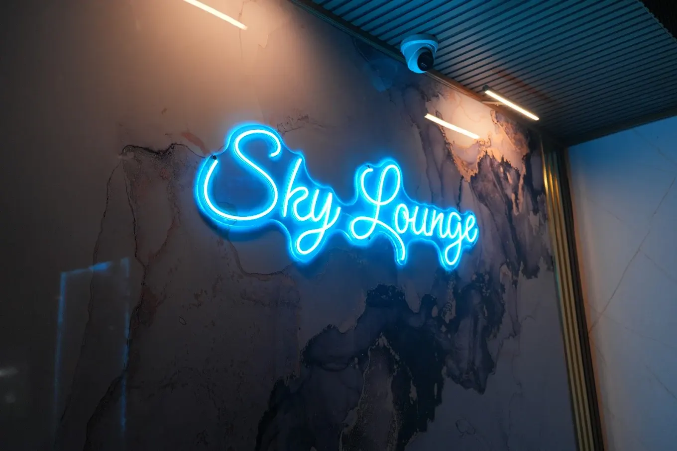 Sky Lounge neon sign on marble wall
