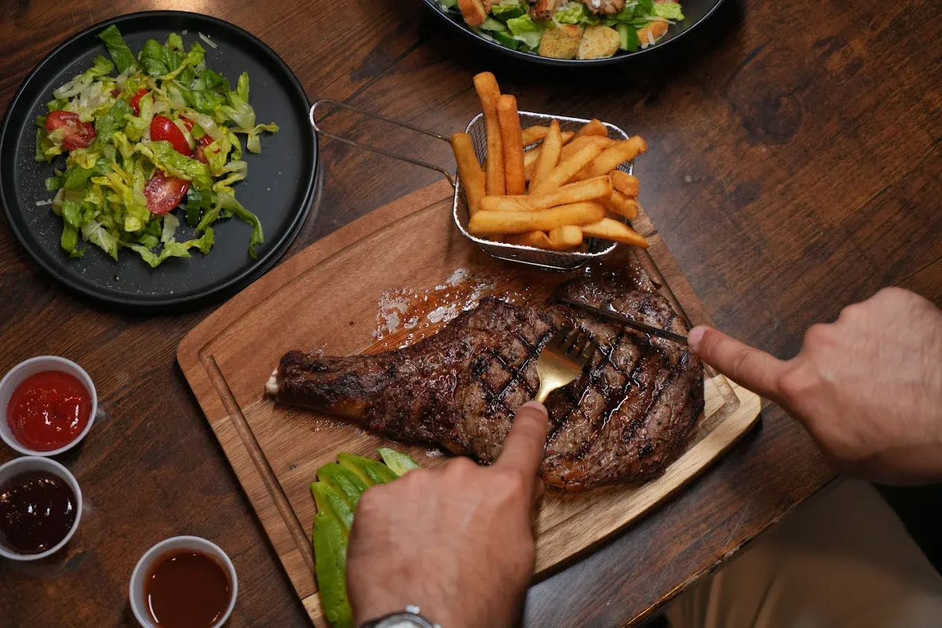 Bone-in steak with fries at Sky Lounge